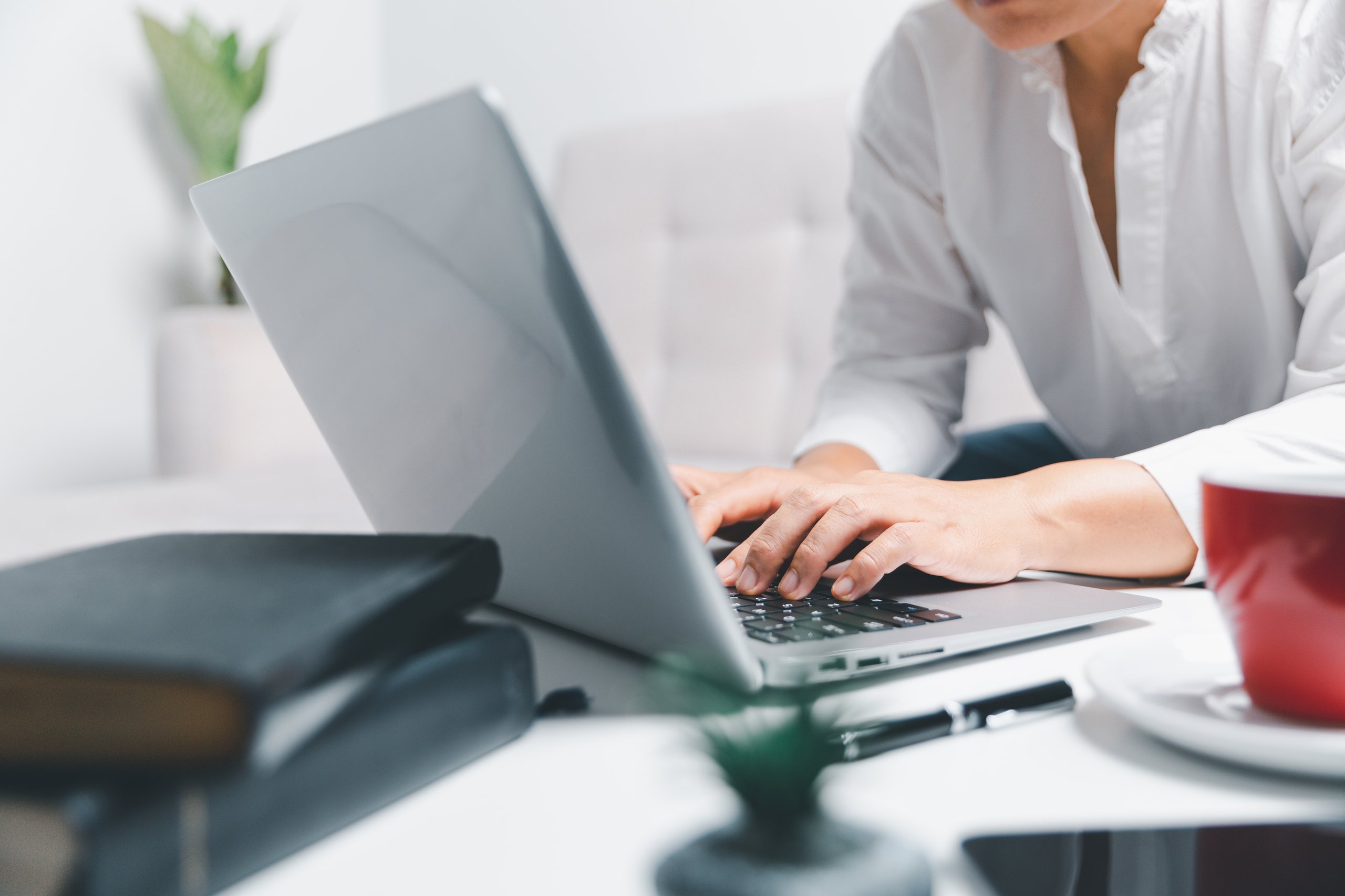 Freelancer working from home with laptop and coffee